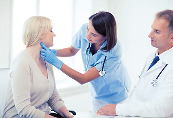 Image showing plastic surgeon or doctor with patient