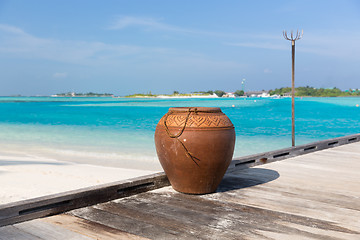 Image showing maldives island beach with vase on wood flooring