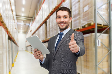 Image showing businessman with tablet pc over warehouse