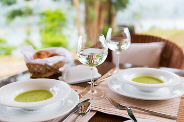 Image showing close up of soup and water glasses at restaurant