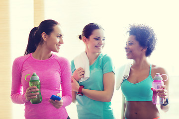 Image showing happy women with bottles of water in gym