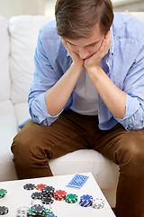 Image showing man with playing cards and chips at home