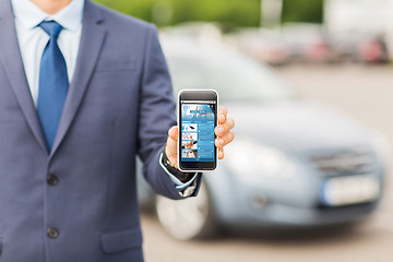 Image showing close up of business man with smartphone and car