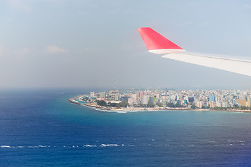 Image showing close up of airplane wing above Maldives and ocean