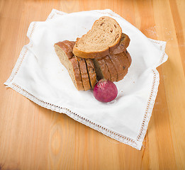Image showing Freshly baked bread with homespun fabric 