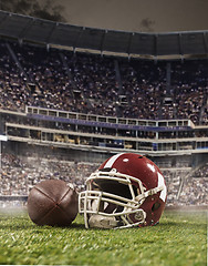 Image showing The ball of american football players and helmet on stadium background