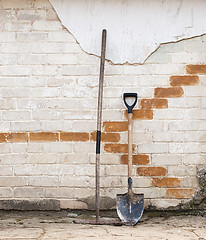 Image showing shovel and rake near the wall