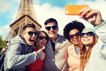 Image showing smiling friends taking selfie with smartphone