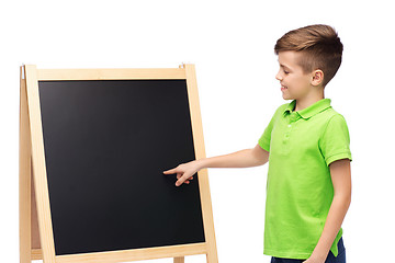 Image showing happy boy with chalk and blank school blackboard