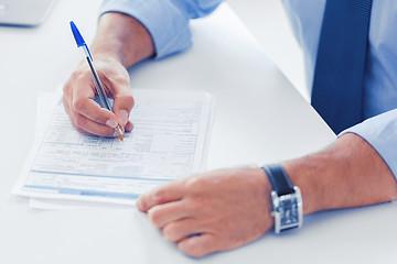 Image showing man signing a contract