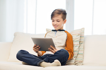 Image showing smiling boy with tablet computer at home