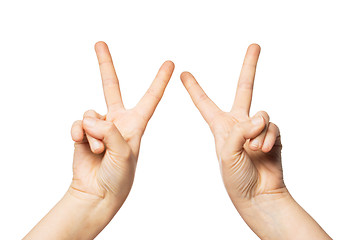Image showing close up of hands showing peace or victory sign