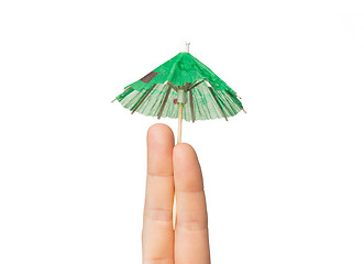 Image showing close up of two fingers with cocktail umbrella