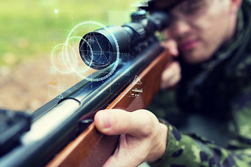 Image showing close up of soldier or sniper with gun in forest