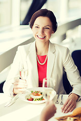 Image showing happy woman drinking champagne at restaurant