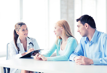 Image showing doctor with patients in cabinet