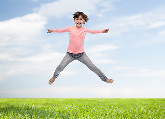 Image showing happy little girl jumping in air