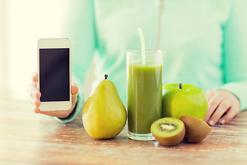 Image showing close up of woman hands smartphone and fruit juice