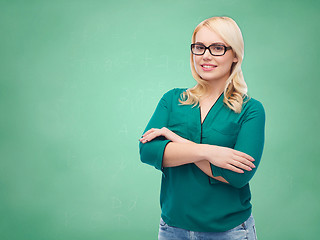 Image showing smiling young woman with eyeglasses