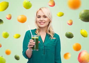 Image showing smiling woman drinking vegetable juice or smoothie