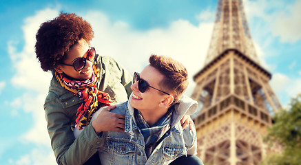 Image showing happy teenage couple over paris eiffel tower