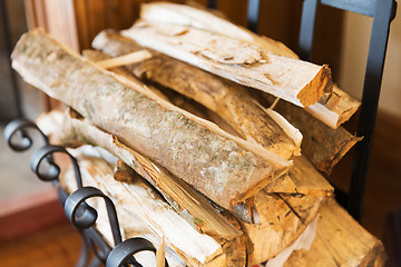 Image showing close up of firewood stack on stand at home