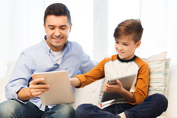 Image showing happy father and son with tablet pc at home