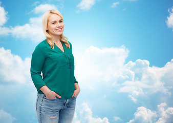 Image showing smiling young woman in shirt and jeans