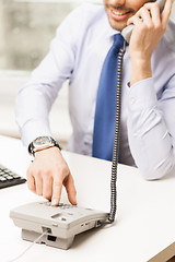 Image showing businessman dialing number and calling on phone