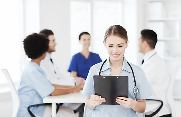 Image showing happy doctor over group of medics at hospital