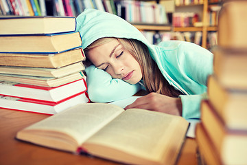 Image showing student or woman with books sleeping in library