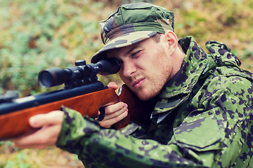 Image showing young soldier or hunter with gun in forest