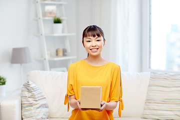 Image showing happy asian young woman with parcel box at home