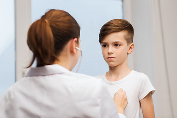 Image showing doctor with stethoscope listening to child