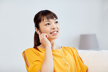 Image showing happy asian woman with earphones listening music