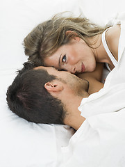 Image showing attractive couple in love under white bed sheets