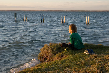 Image showing boy looking over lake