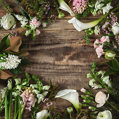 Image showing Frame from flowers on wooden background