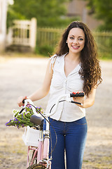 Image showing Girl with her bicycle