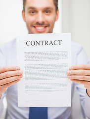 Image showing close up of businessman holding contract document