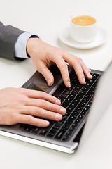 Image showing close up of businessman hands typing on laptop