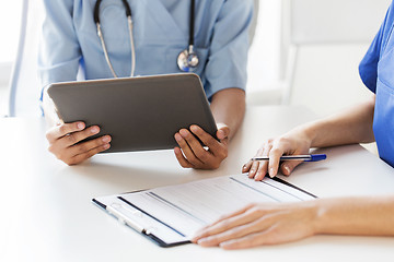 Image showing close up of doctors with tablet pc at hospital