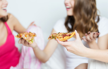 Image showing happy friends or teen girls eating pizza at home