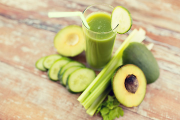 Image showing close up of fresh green juice glass and vegetables