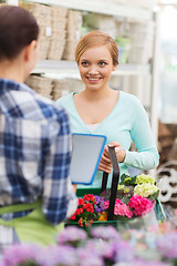 Image showing happy women with tablet pc at flower shop