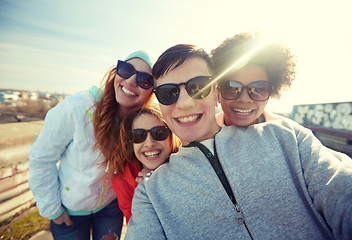 Image showing group of happy friends taking selfie on street