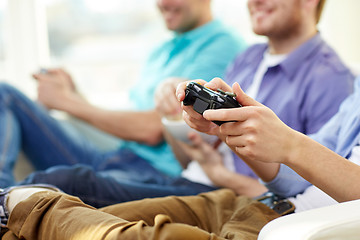 Image showing close up of friends playing video games at home