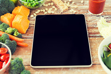 Image showing close up of blank tablet pc screen and vegetables