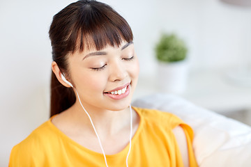 Image showing happy asian woman with earphones listening music