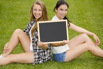 Image showing Tennage students holding a chalkboard